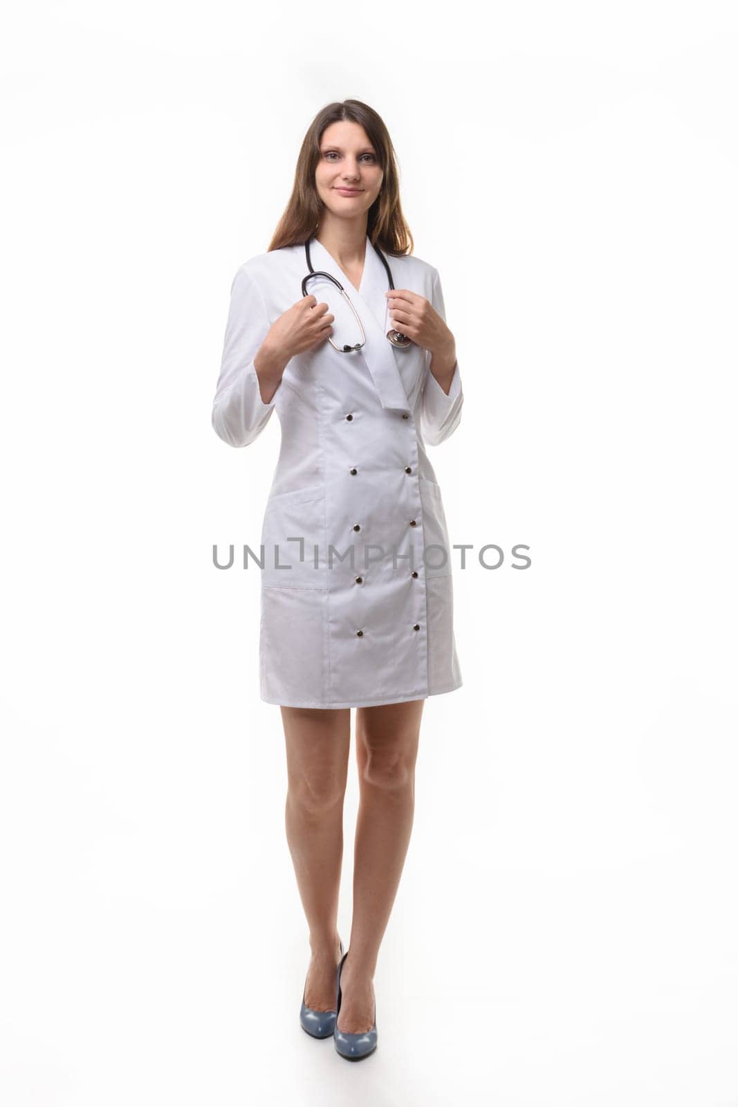 girl doctor in white robe with stethoscope on white background