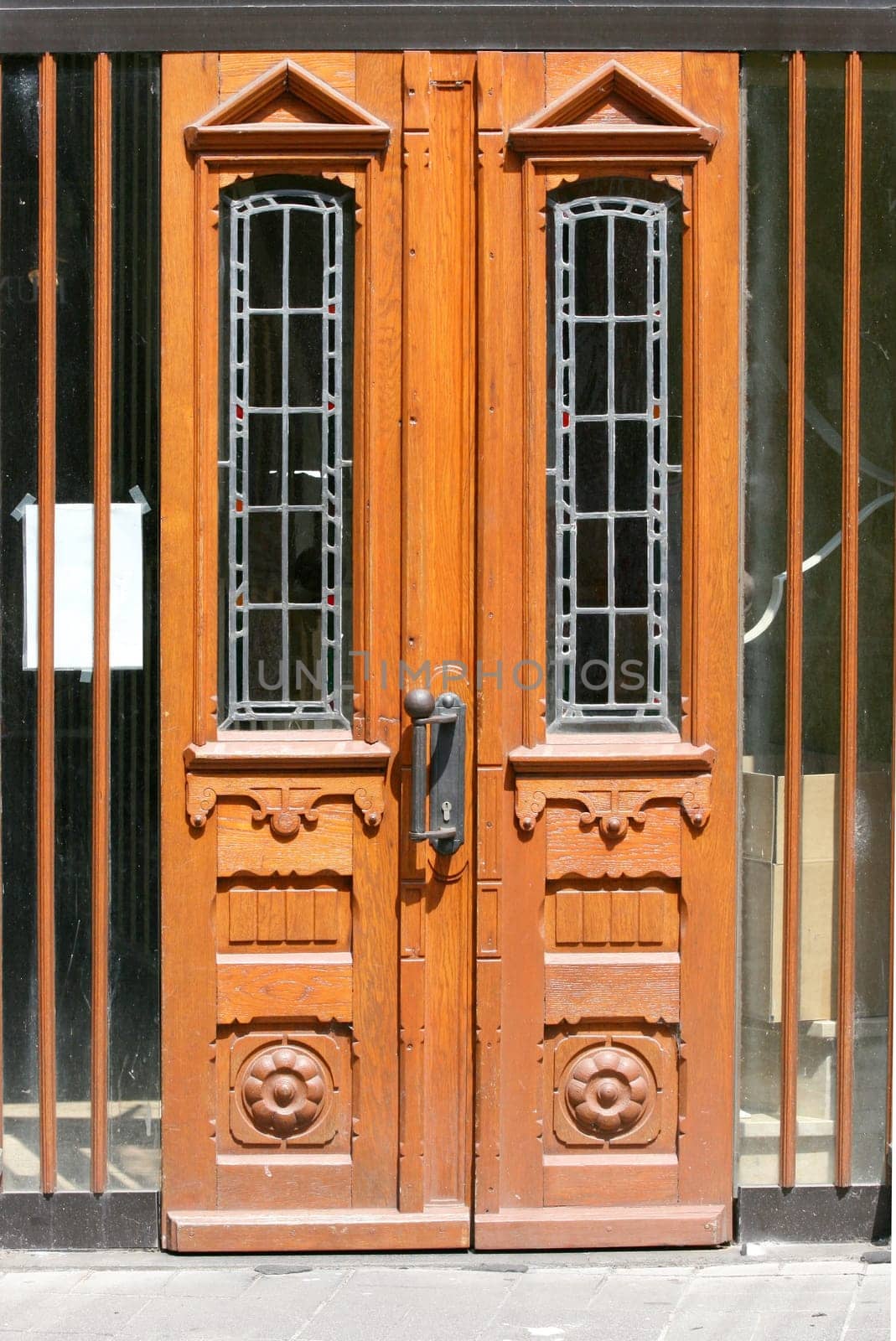 a front door with stained glass and wooden ornaments.