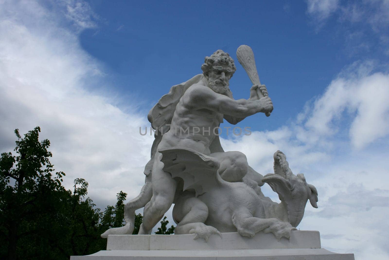 Imaginative sculpture made of gray stone, with blue sky background .
