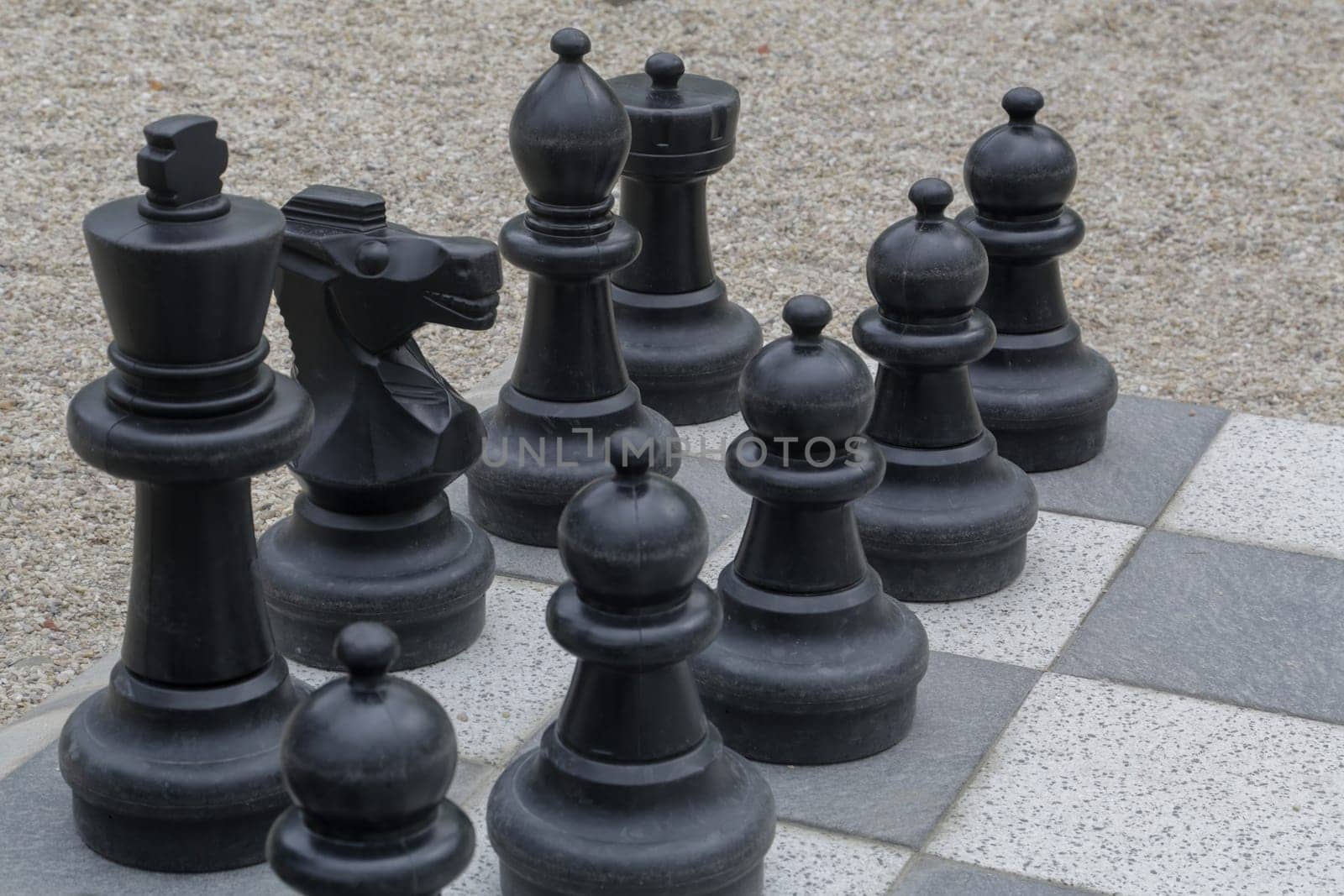 Black and white king on a chess board in open air