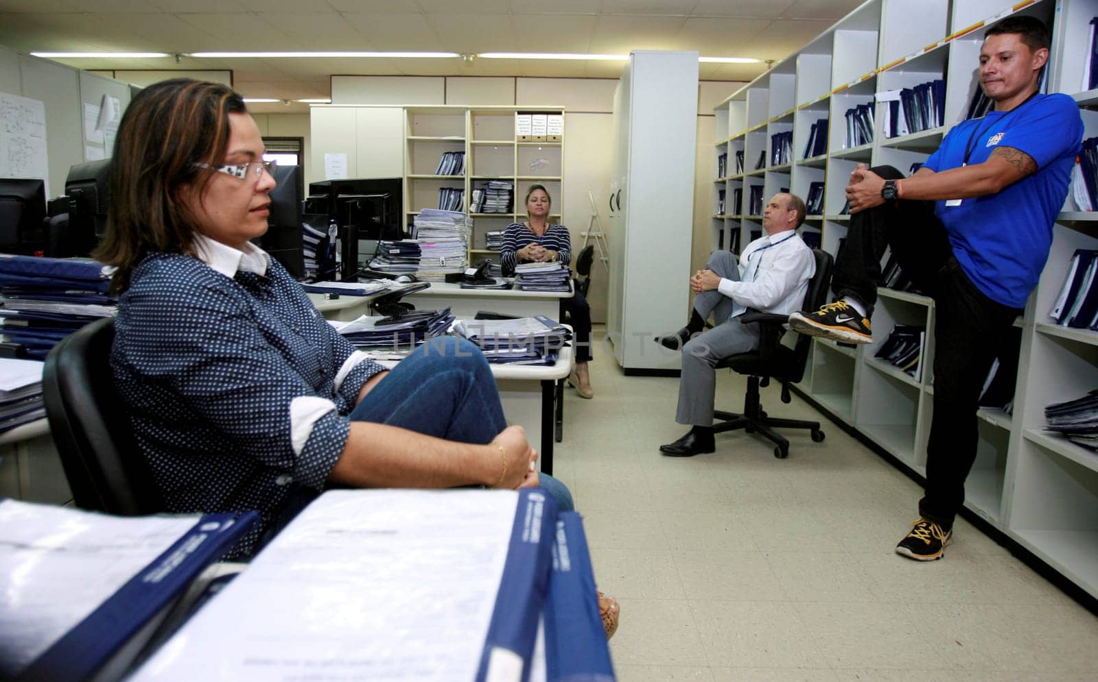 salvador, bahia / brazil - december 17, 2014: employees of the regional labor court in the city of Salvador are seen doing work gymnastics in the workplace.