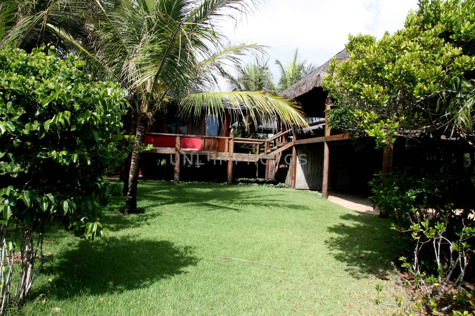 porto seguro, bahia / brazil - jeneiro 15, 2008: beach house with a piacava fiber roof is seen in the Trancoso district in the city of Porto Seguro.