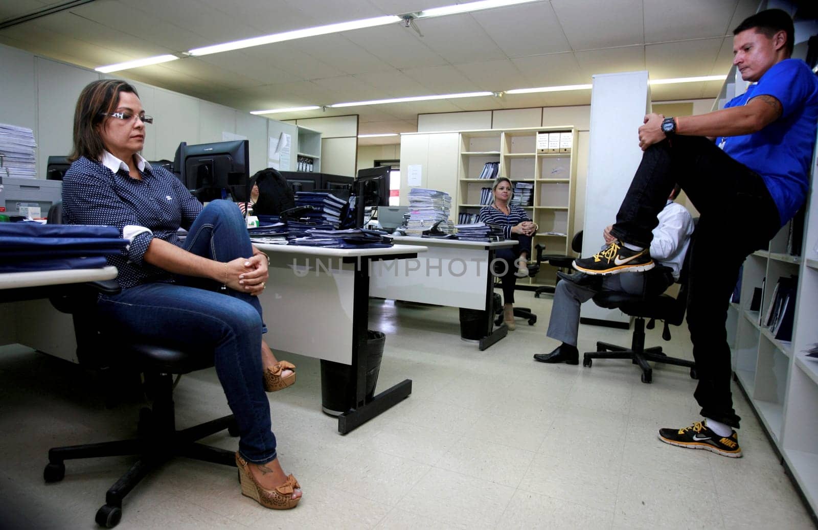salvador, bahia / brazil - december 17, 2014: employees of the regional labor court in the city of Salvador are seen doing work gymnastics in the workplace.