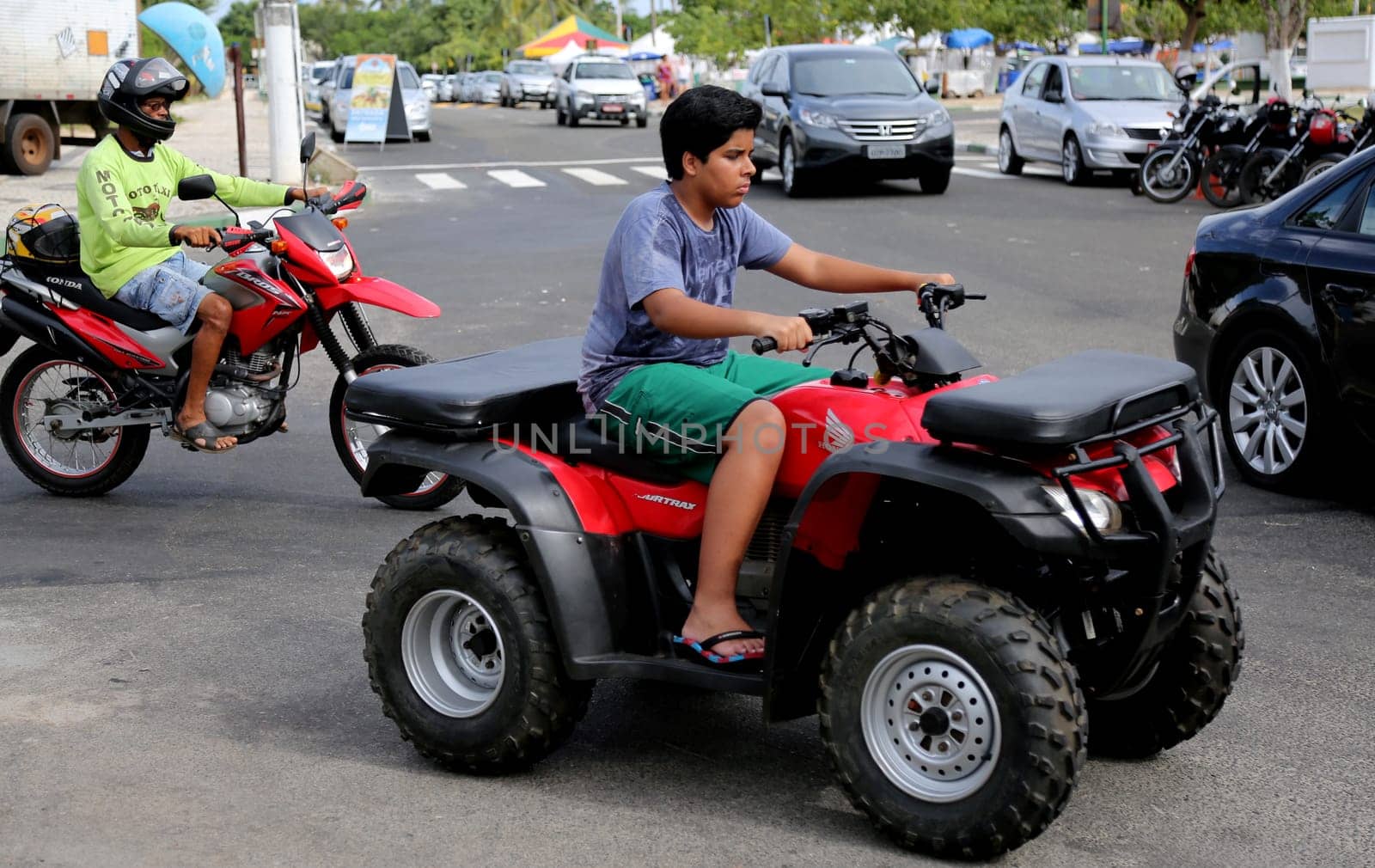 camacari, bahia / brazil - january 22, 2015: young man is seen without protective equipment, flying a quad in the Guarajuba district in the city of Camacari.