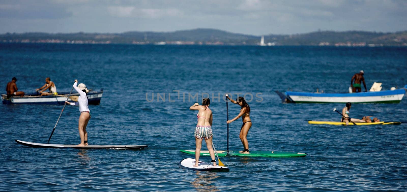 salvador, bahia / brazil - october 25, 2014: people are seen practicing Stand Up on Porto da Barra beach in the city of Salvador.