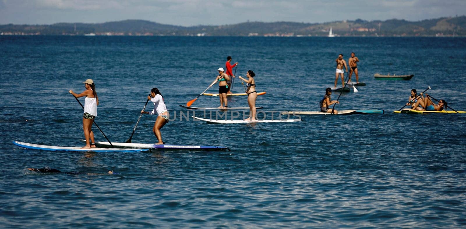 salvador, bahia / brazil - october 25, 2014: people are seen practicing Stand Up on Porto da Barra beach in the city of Salvador.
