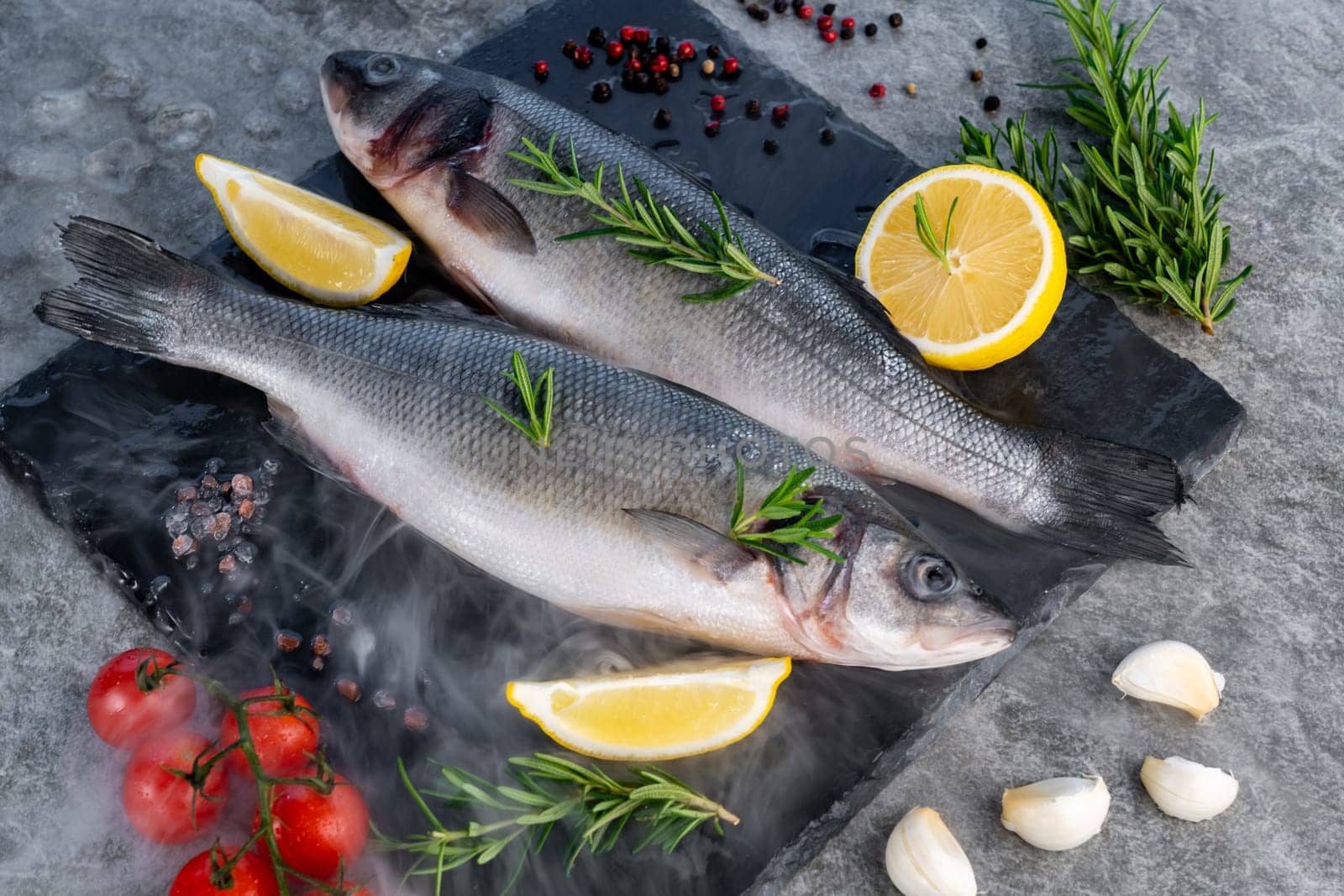 Fresh oyster serve with lemon in basket on black stone plate. Fresh seafood food and european cuisine gourmet concept.