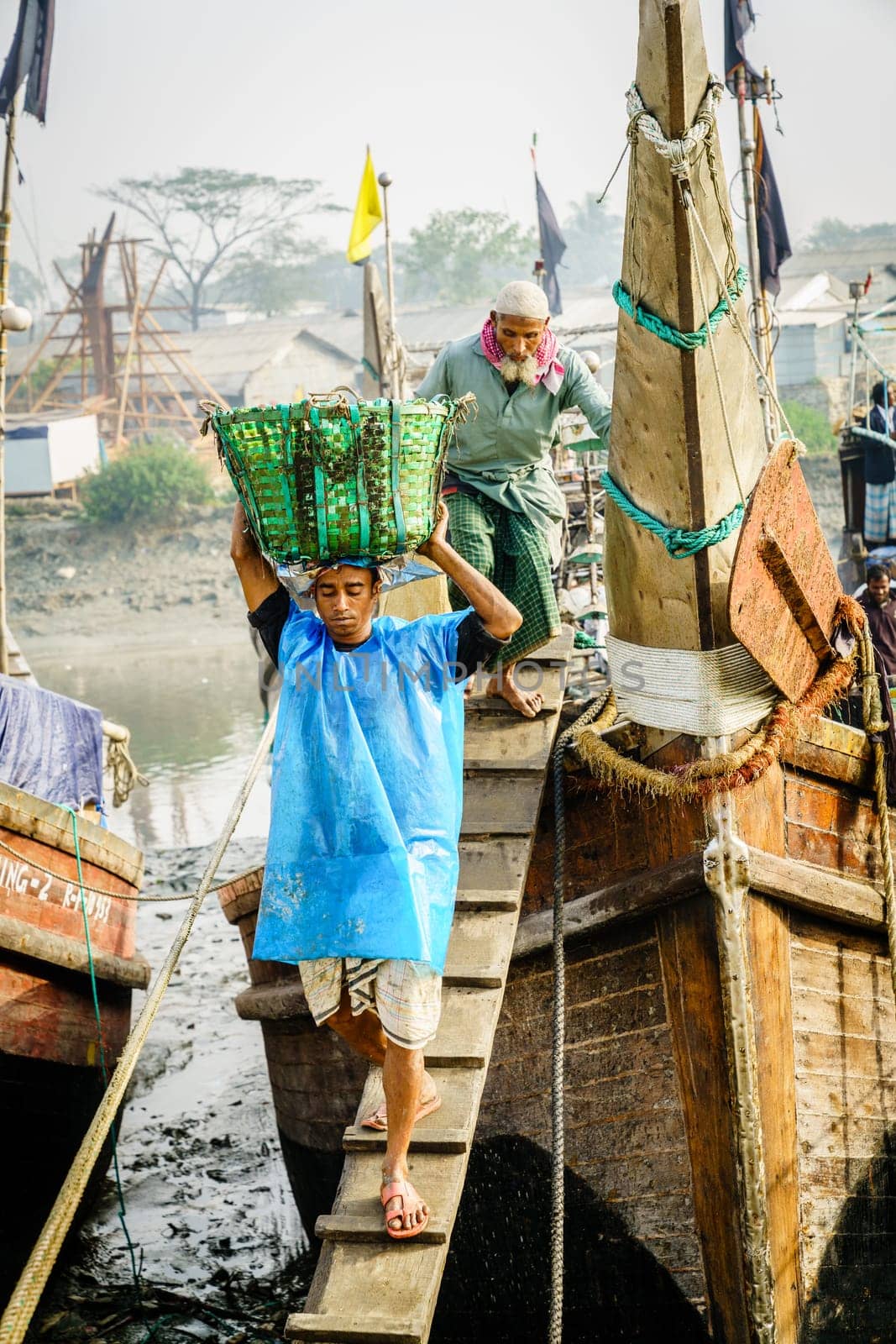 Chittagong, Bangladesh, December 23, 2017: Fishermen bringing fresh catch from the boat at the port on the Karnaphuli River in Chittagong