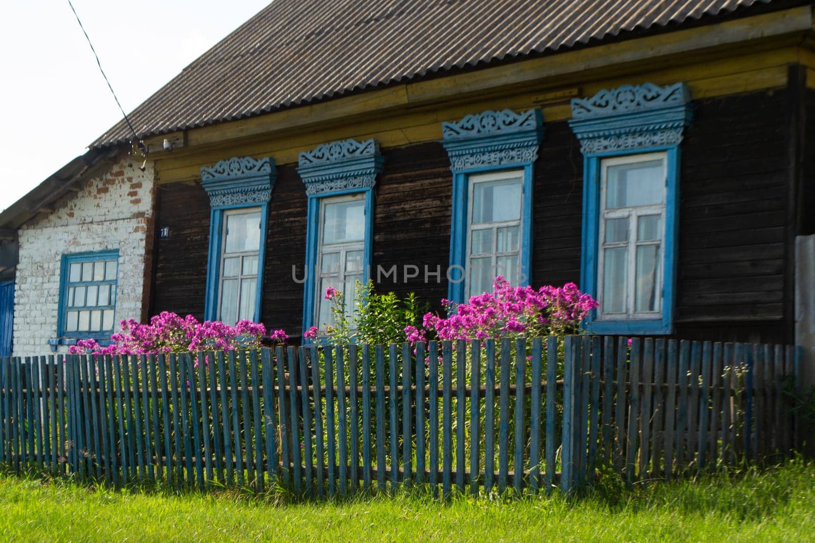 decorative carved window in an old wooden house, rustic decoration of a wooden house, Belarus