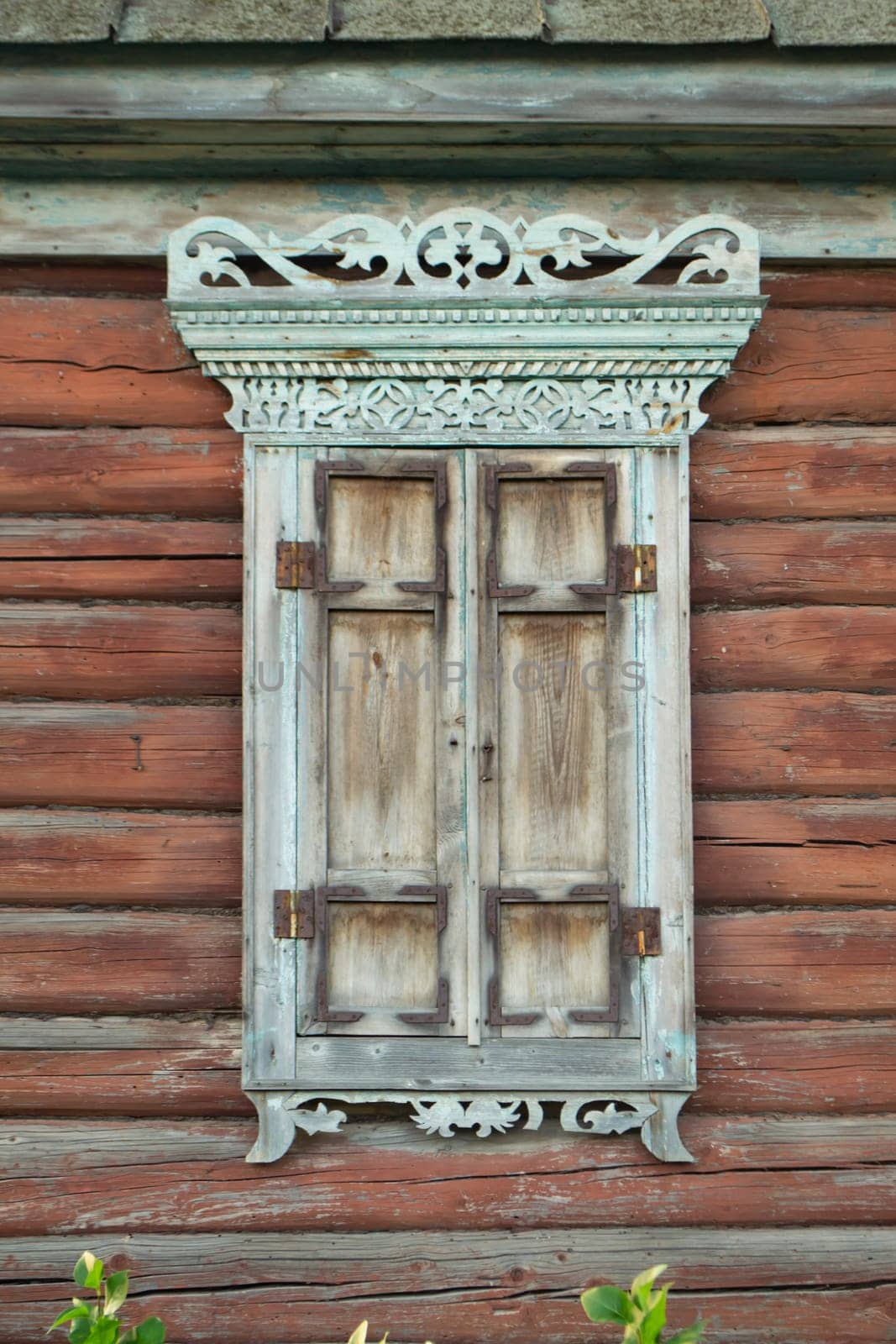 Old house vintage carved windows with wooden lacy shutters close up. Belarus