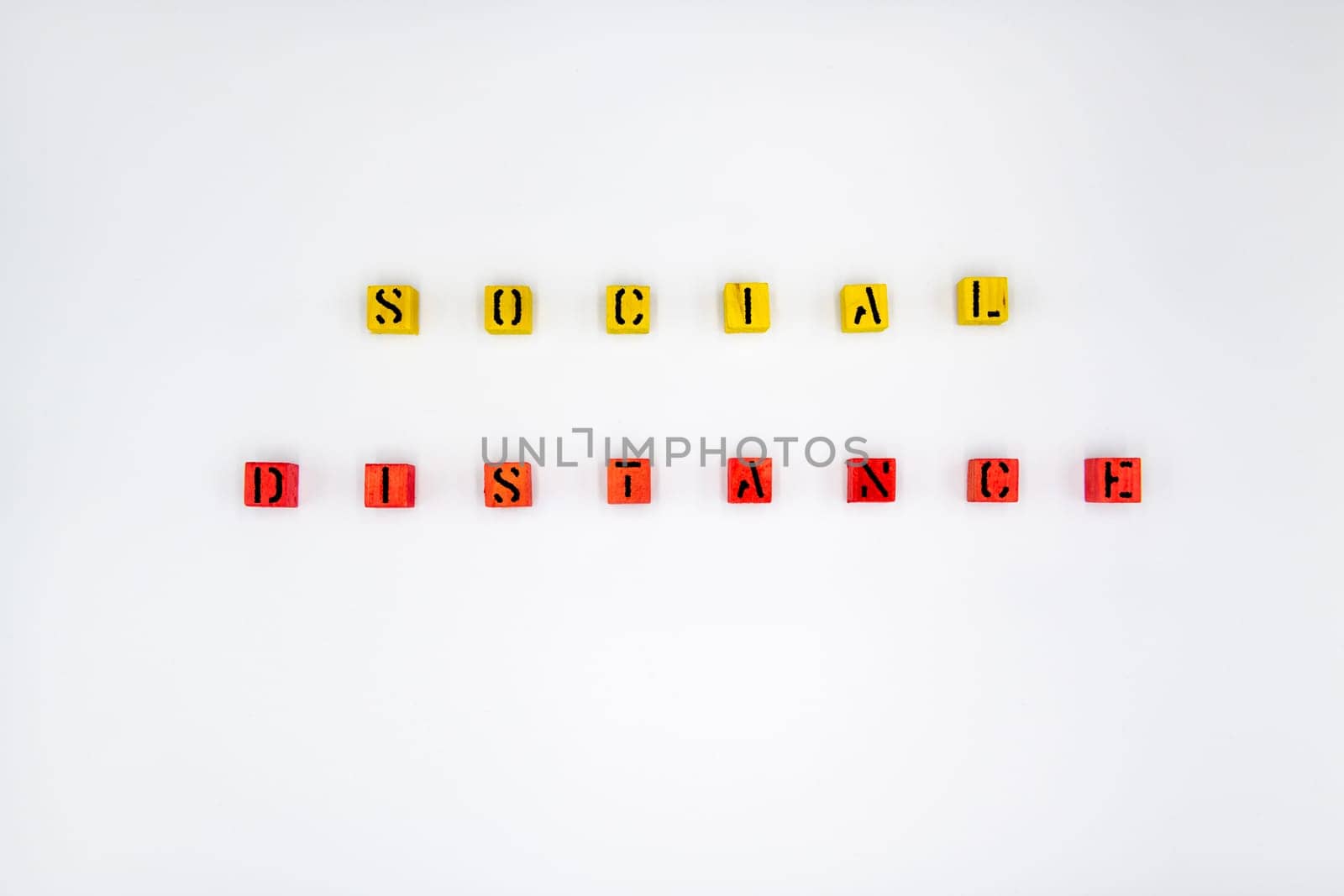 Yellow and red wooden cubes with message Social Distancing isolated on white background