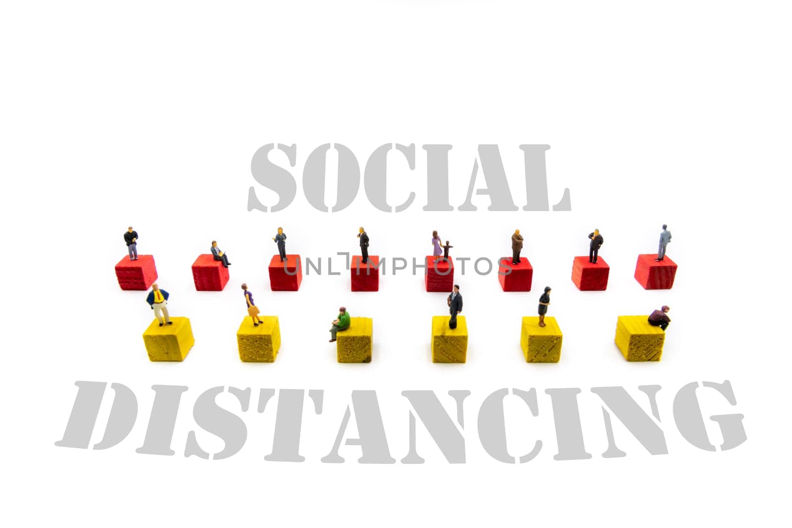 Miniature figurines standing on wooden cubes with message Social Distancing isolated over white background