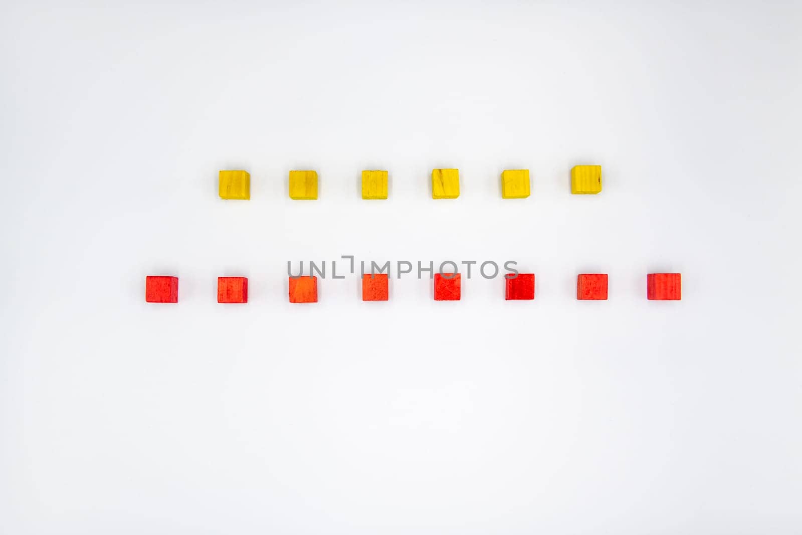 Yellow and red wooden cubes isolated on white background
