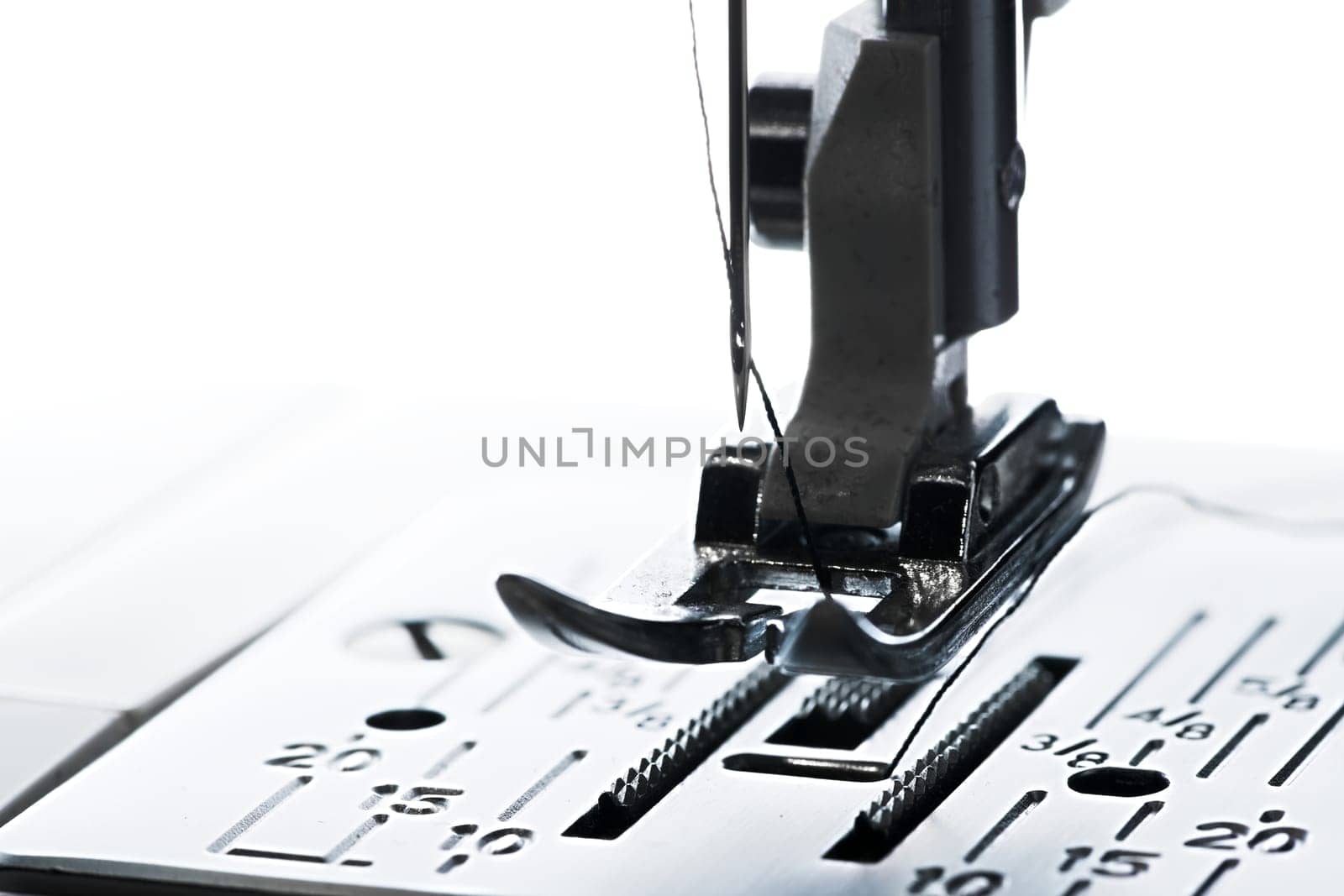 6 - Pure white plain background, dark silhouette of ready to go sewing machine, leading left to right with copy space.