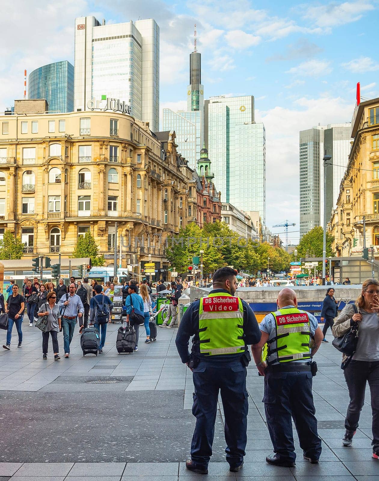 FRANKFURT, GERMANY - AUGUST 31, 2018: Central square crowded with people, skyscrapers of modern architecture, cityscape in sunset light