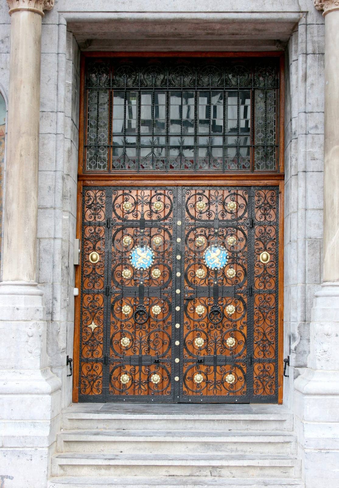 a front door with metal ornaments and wood ornaments.