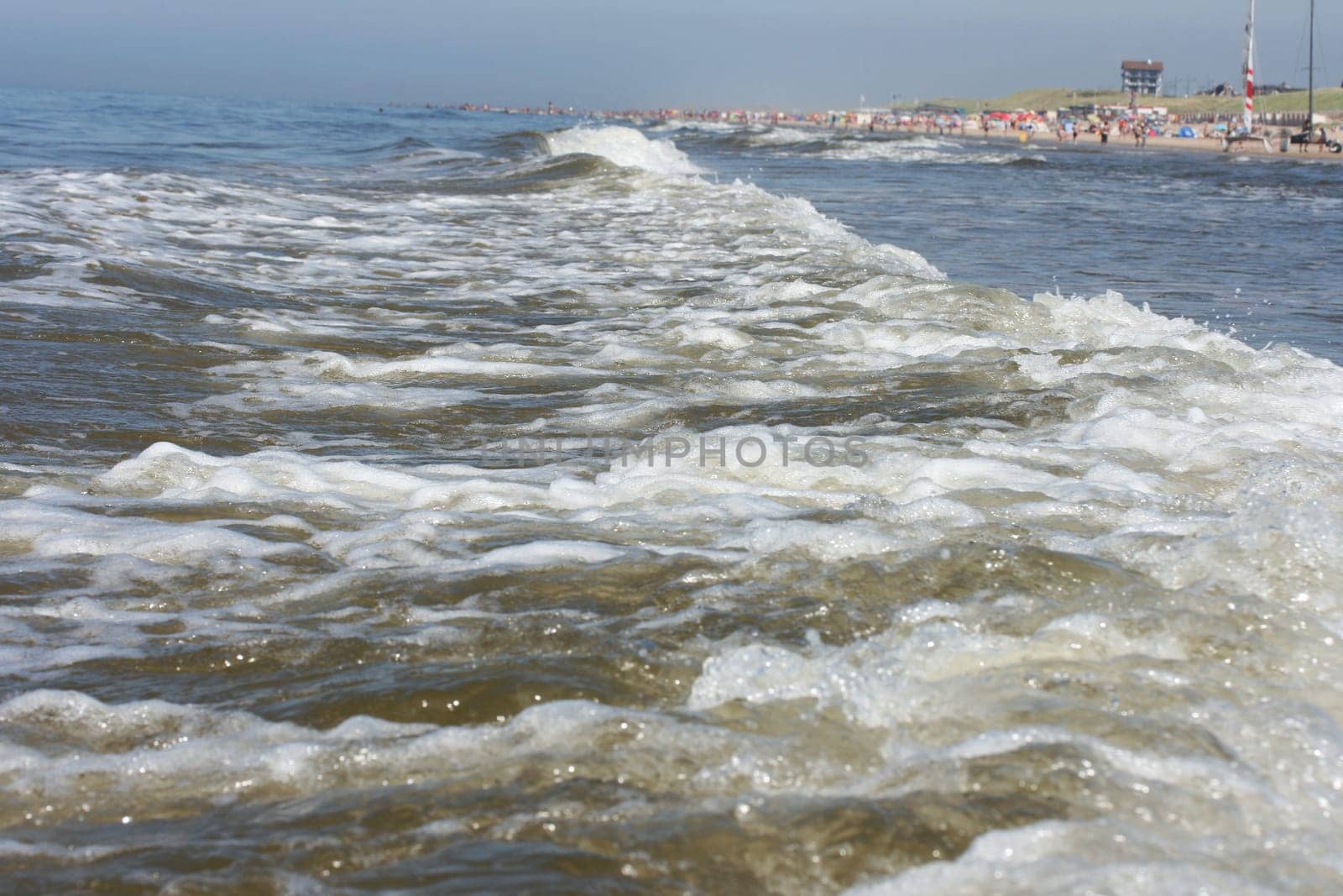 Waves of white foam Crown roll over the sea surface