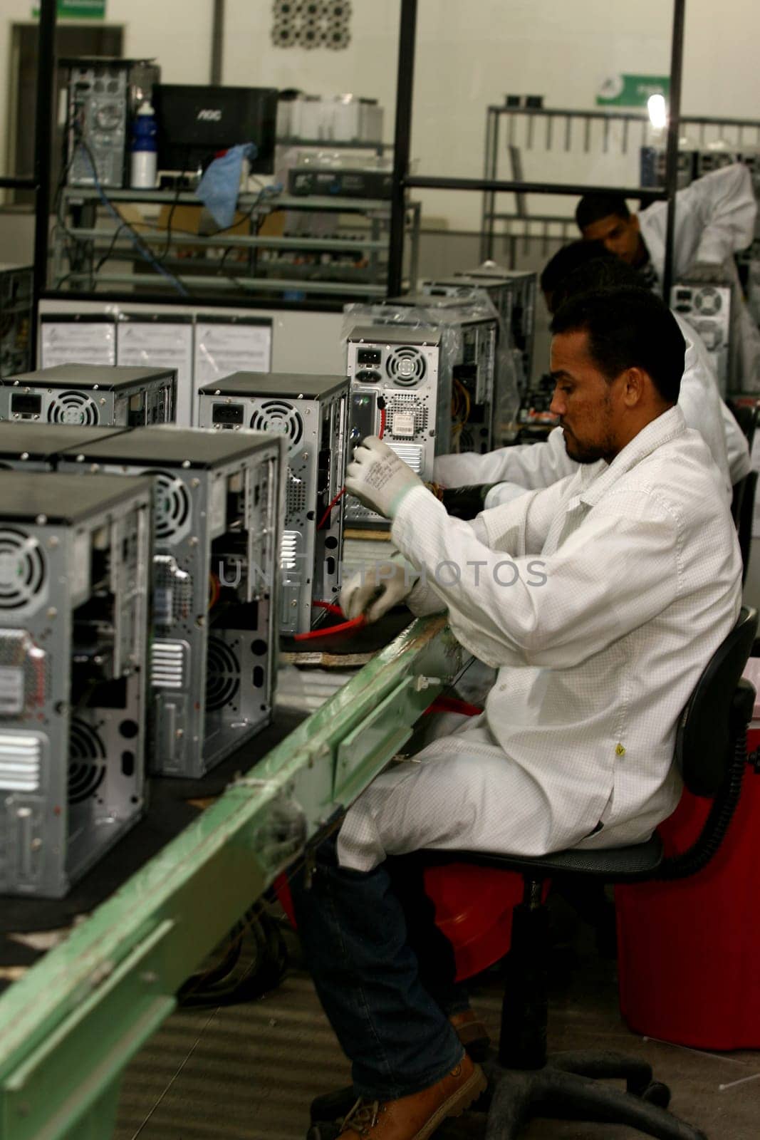 ilheus, bahia / brazil - june 13, 2011: workers are seen on a computer assembly line in a factory at the Informatics Pole in the city of Ilheus, in southern Bahia.