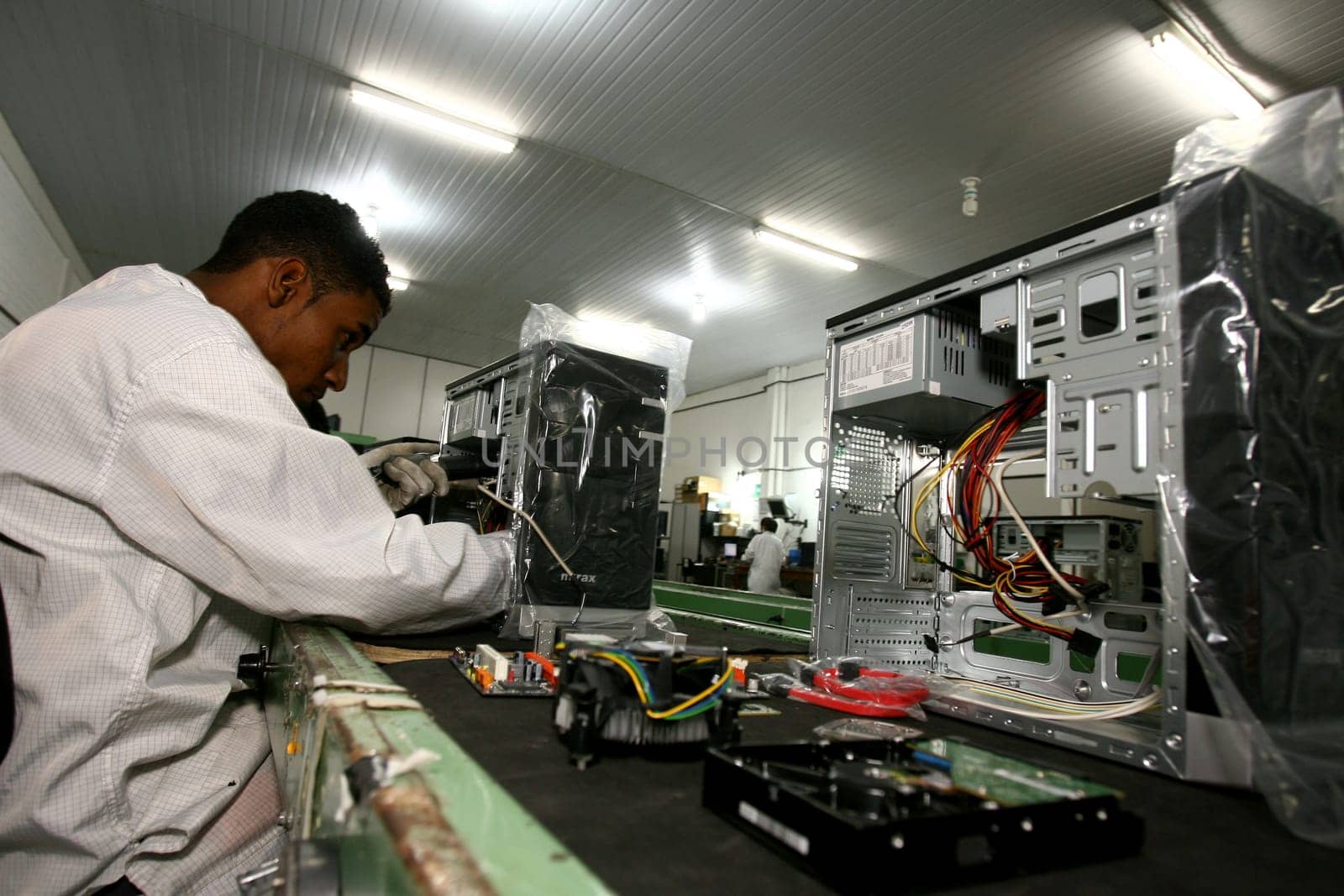 ilheus, bahia / brazil - june 13, 2011: workers are seen on a computer assembly line in a factory at the Informatics Pole in the city of Ilheus, in southern Bahia.
