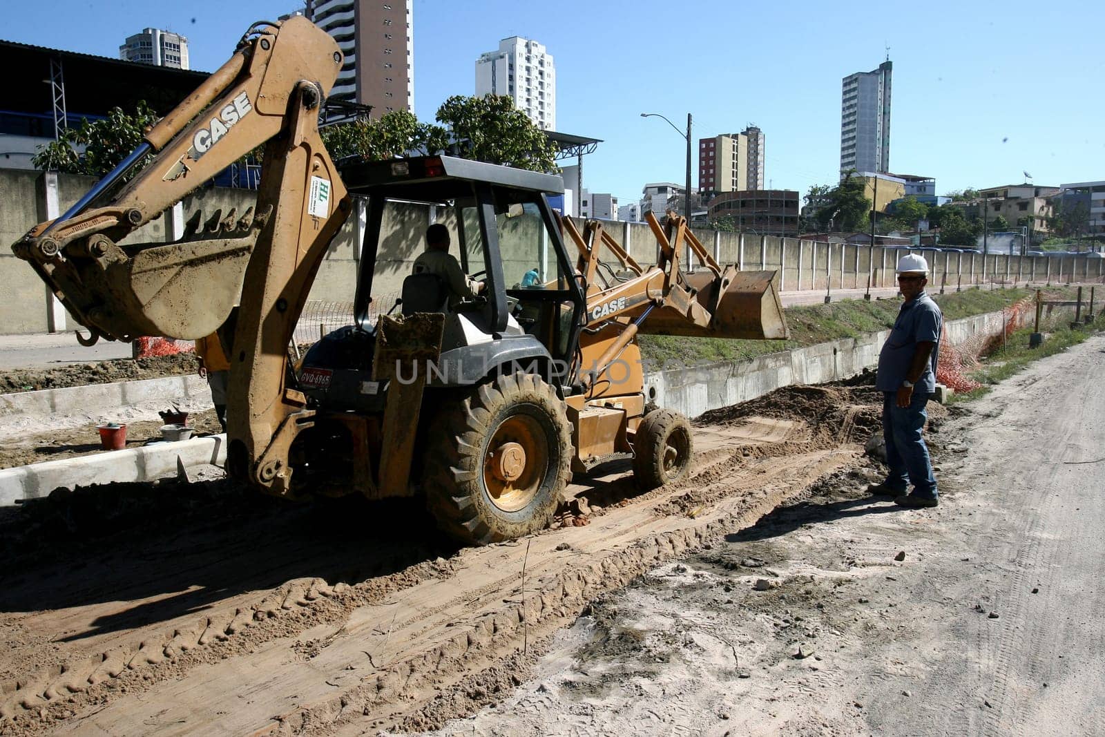 itabuna, bahia / brazil - december 9, 2011: machines and workers are seen during construction of Canal Lava Pes to drain the sewage network in the city of Itabuna, in southern Bahia.