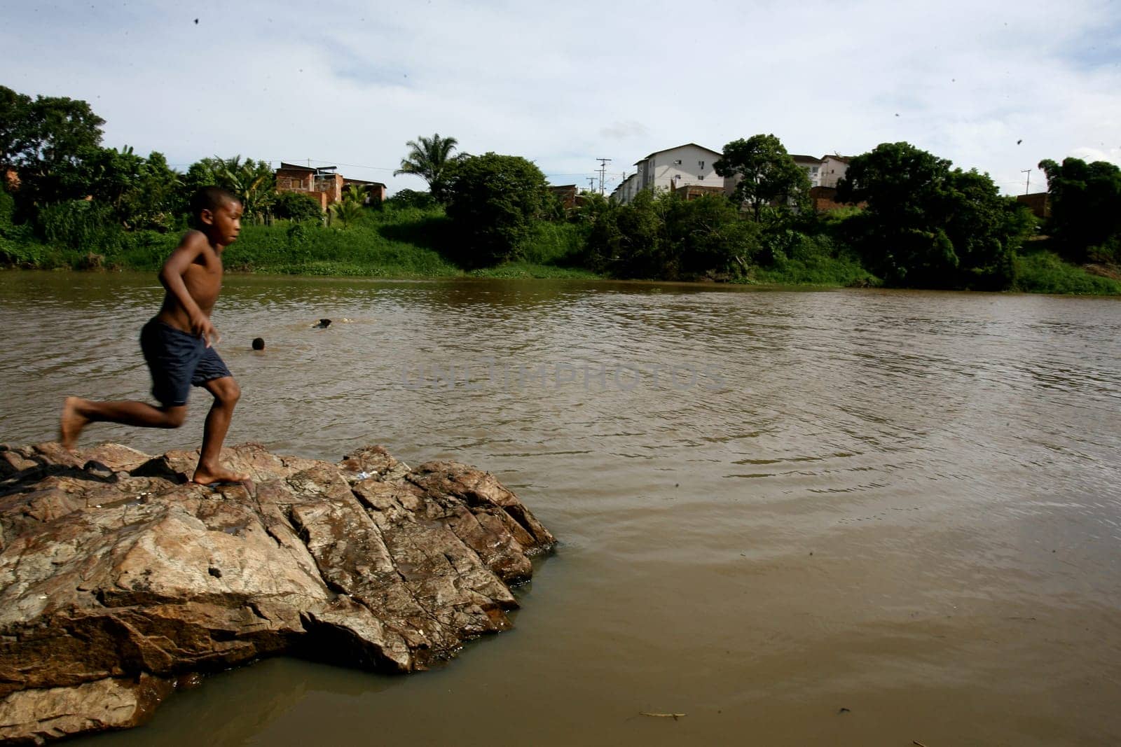 itabuna, bahia / brazil - december 20, 2011: young people are seen along the banks of the Cachoeira river in the city of Itabuna, southern Bahia.
