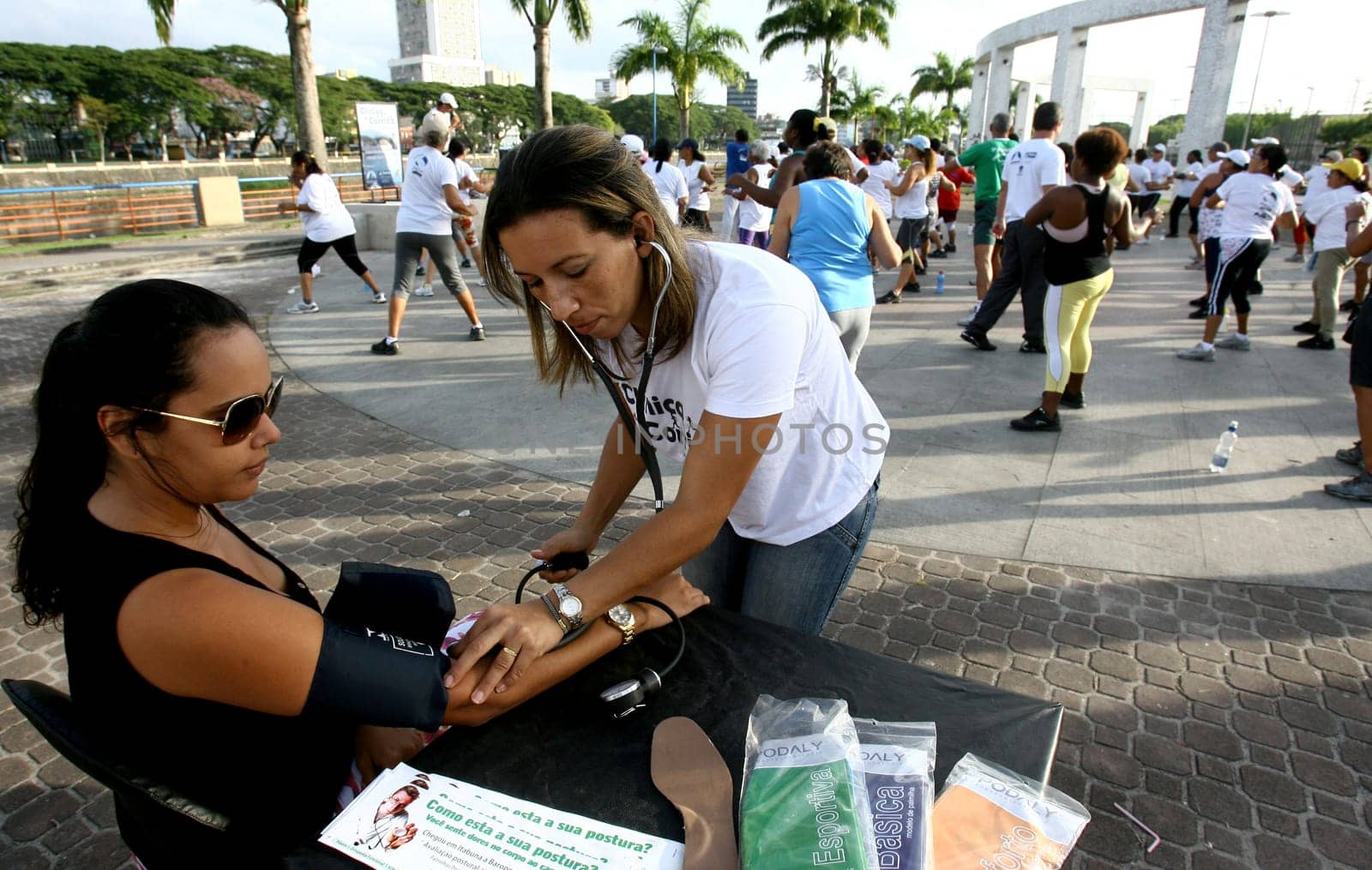 itabuna, bahia / brazil - march 23, 2012: nursing technician measures blood pressure in person in the city of Itabuna, during social action.