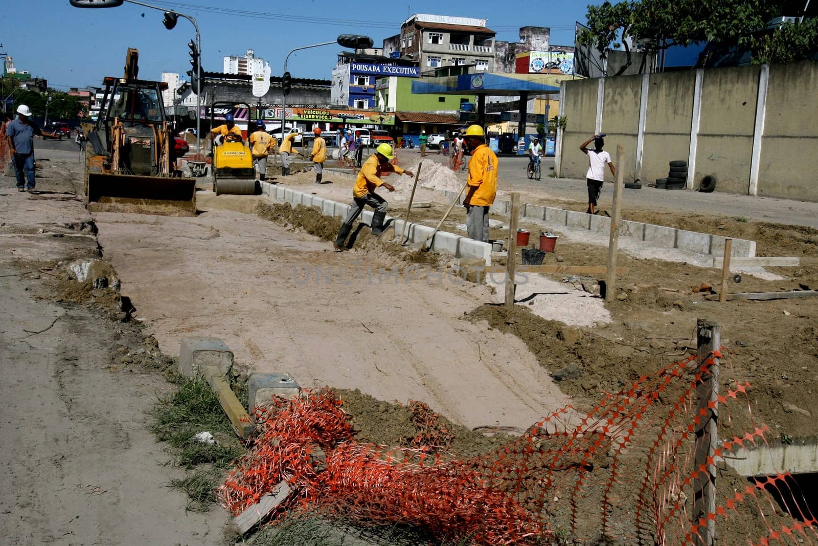 itabuna, bahia / brazil - december 9, 2011: machines and workers are seen during construction of Canal Lava Pes to drain the sewage network in the city of Itabuna, in southern Bahia.