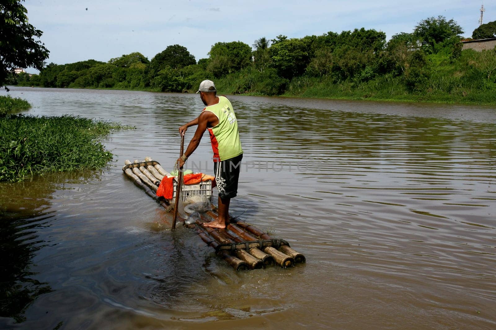 itabuna, bahia / brazil - december 20, 2011: fisherman is seen on a raft in the waters of the Cachoeira river in the city of Itabuna, southern Bahia.