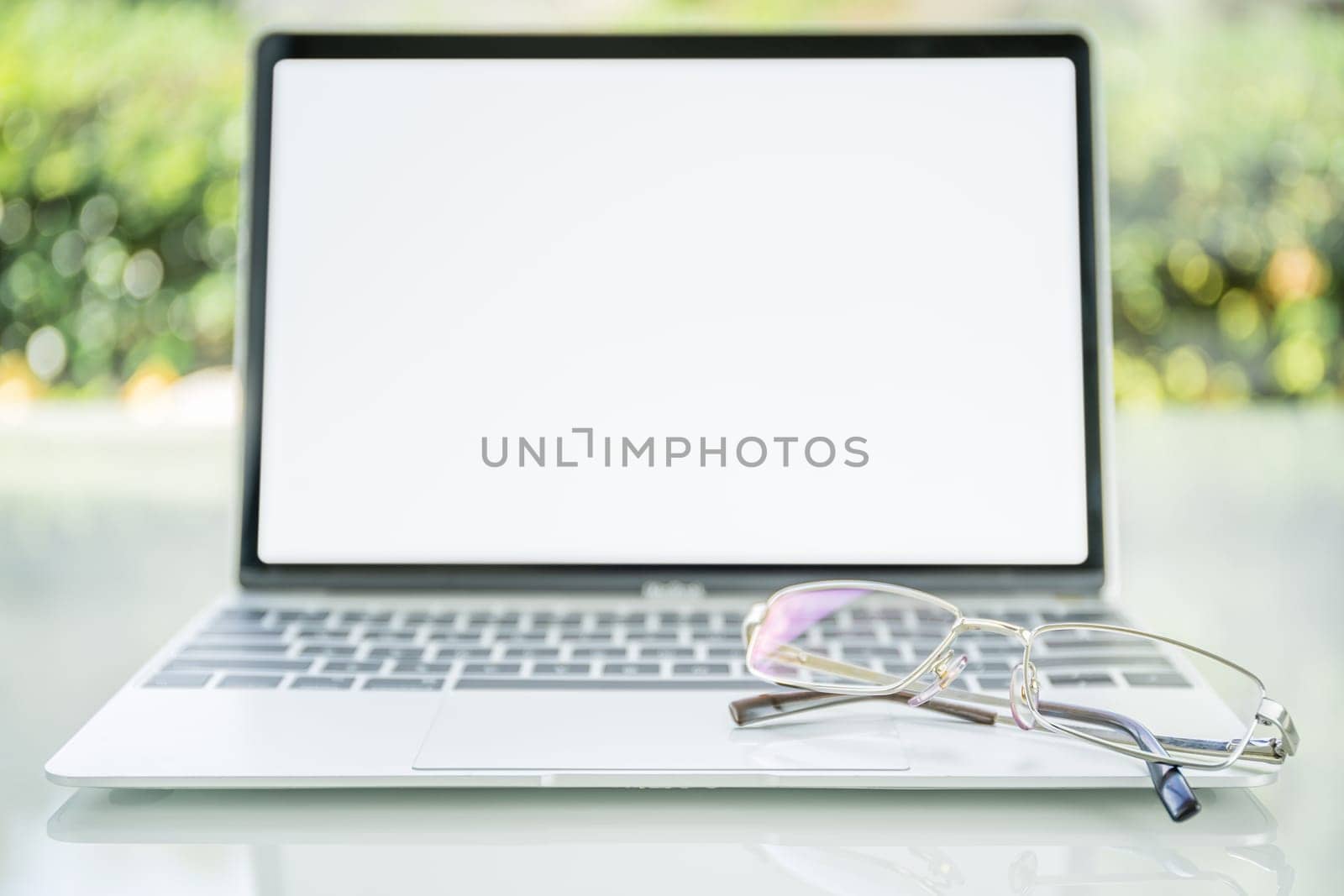 Eye glasses on laptop computer on table at home office