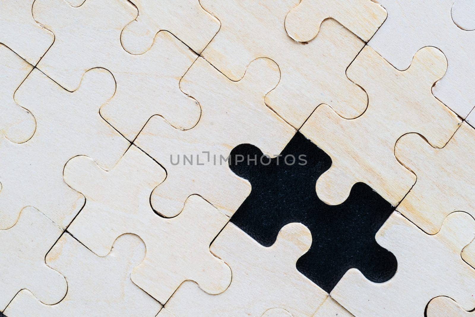 Close up Shot of wooden jigsaw puzzle pieces on black background,Business concept