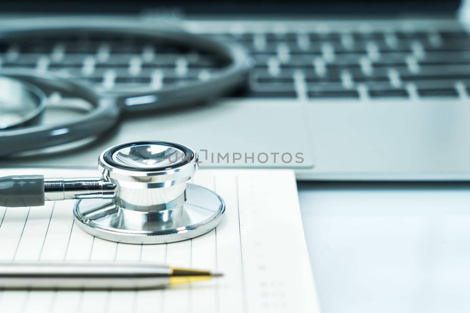 Medical stethoscope for doctor checkup on notepad as medical concept