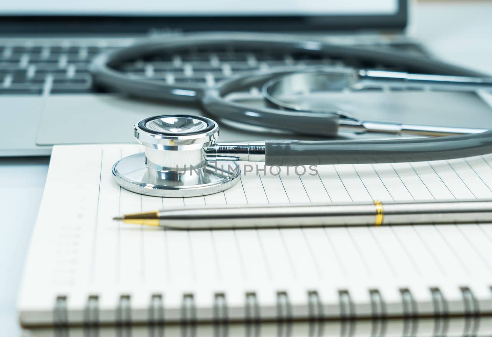 Medical stethoscope for doctor checkup on notepad as medical concept