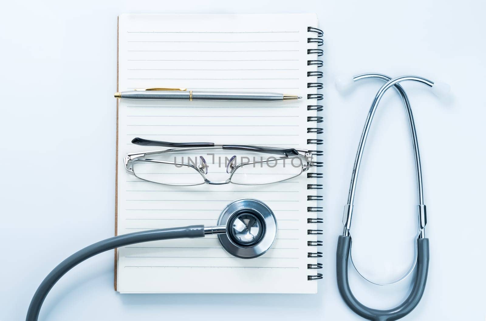 Close up Medical stethoscope with blank notepad as medical concept