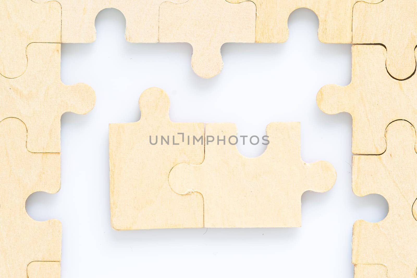 Shot of wooden jigsaw puzzle pieces on white background,Business concept
