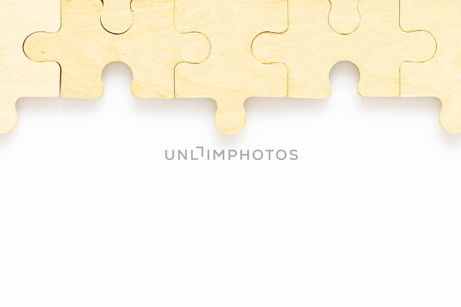 Shot of wooden jigsaw puzzle pieces on white background,Business concept