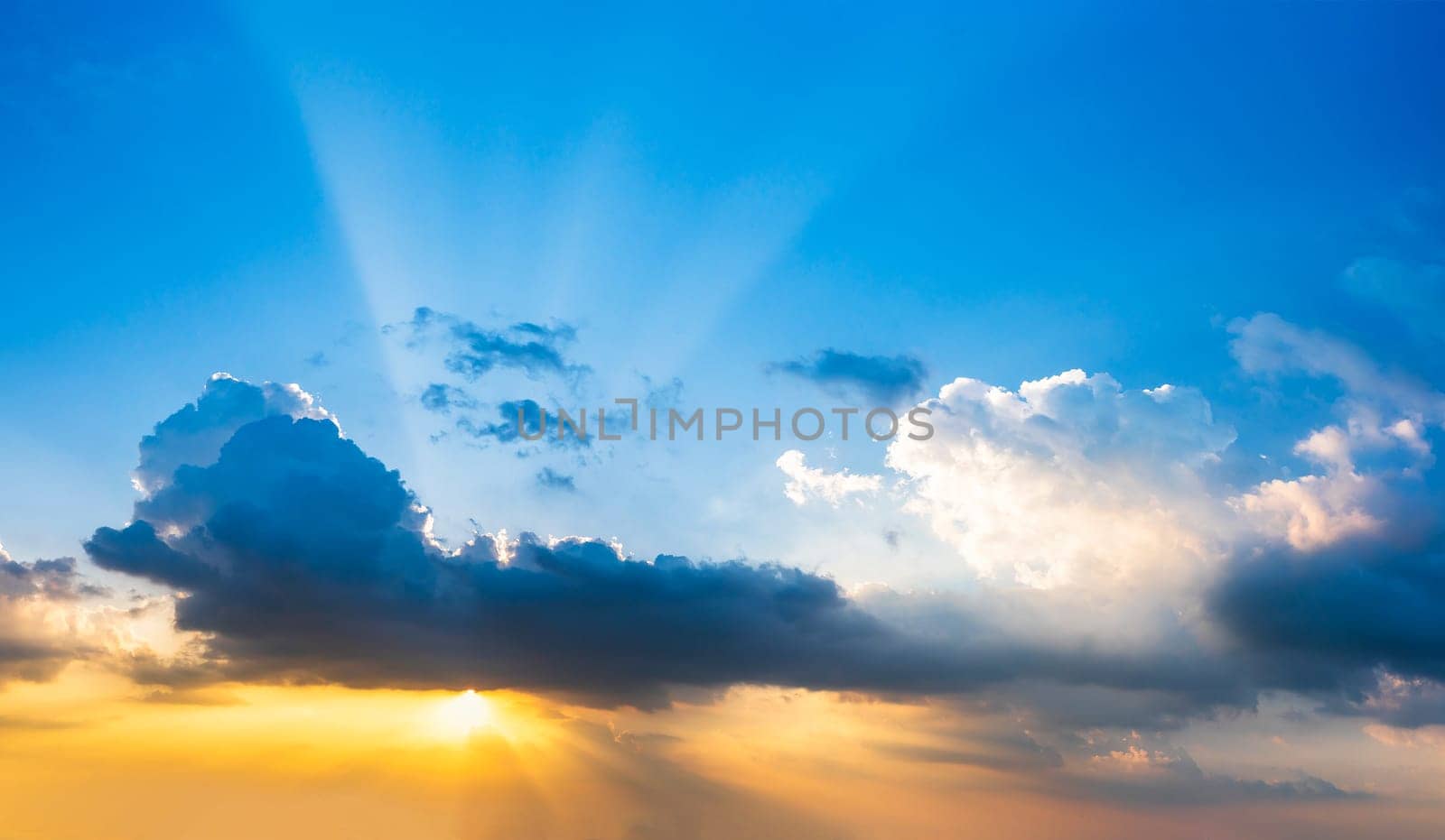 Sunset  with cloud and ray light on clouds in a blue and orange sky in twilight time