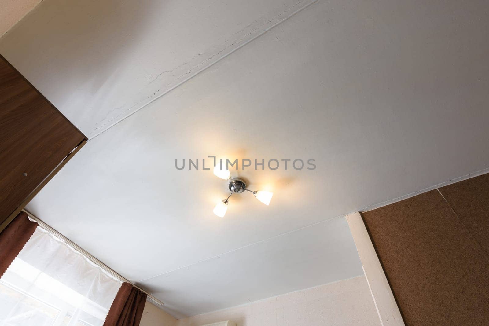 View of the old ceiling in need of repair in the apartment