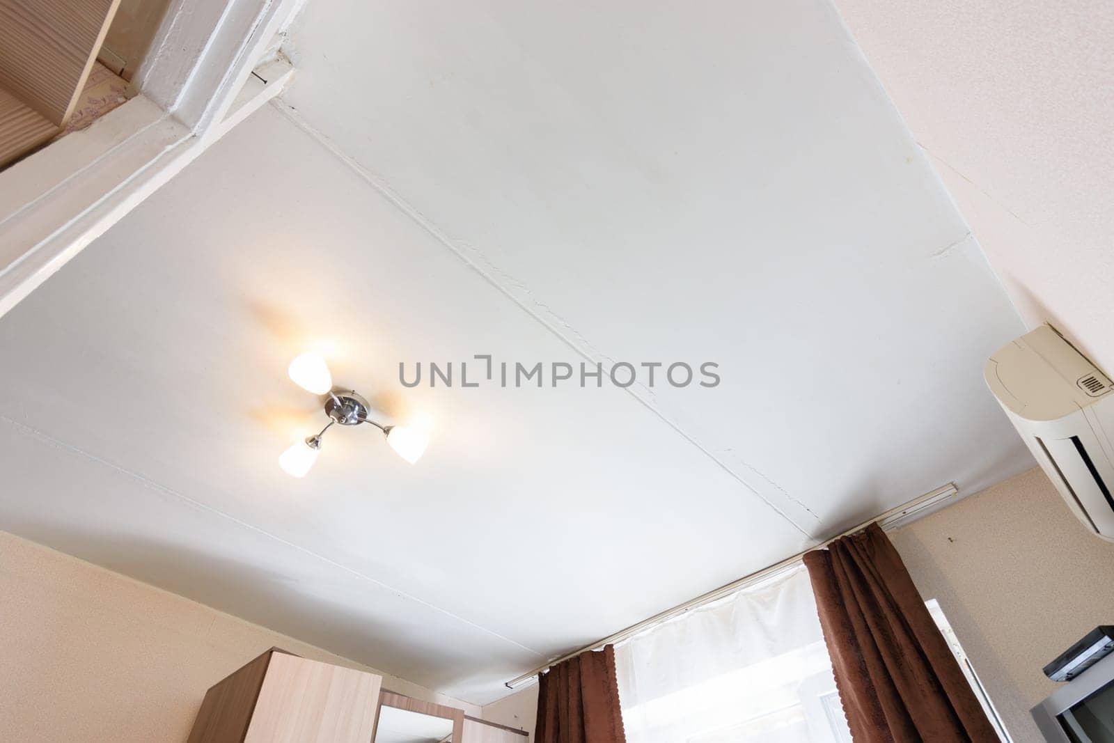 View of the old plastered ceiling in an apartment in need of repair