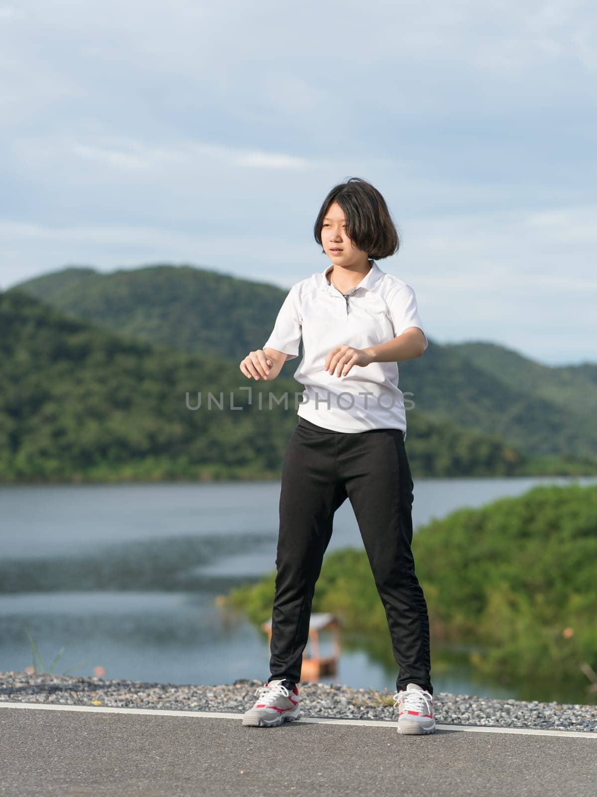 Fitness and lifestyle concept - Young asian woman short hair doing exercising outdoor
