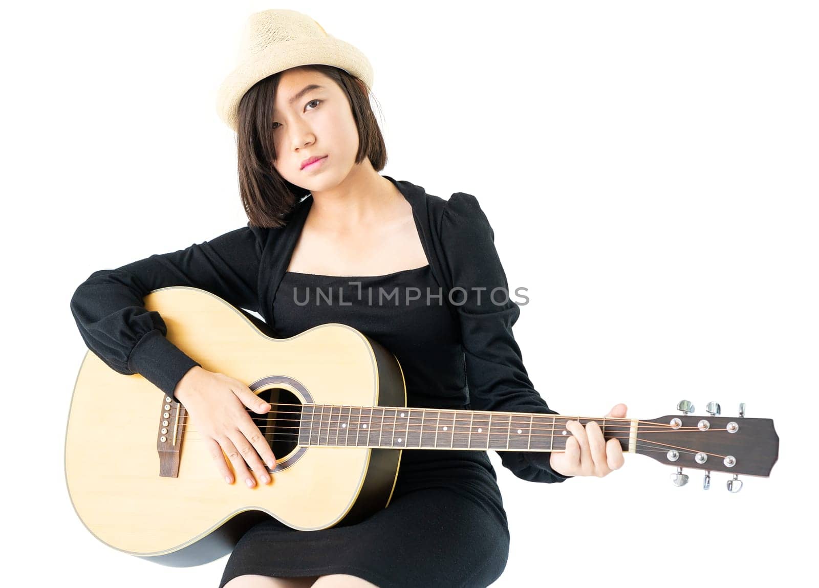 Young asia woman sitting and playing guitar guitar folk song in her hand isolate on white background