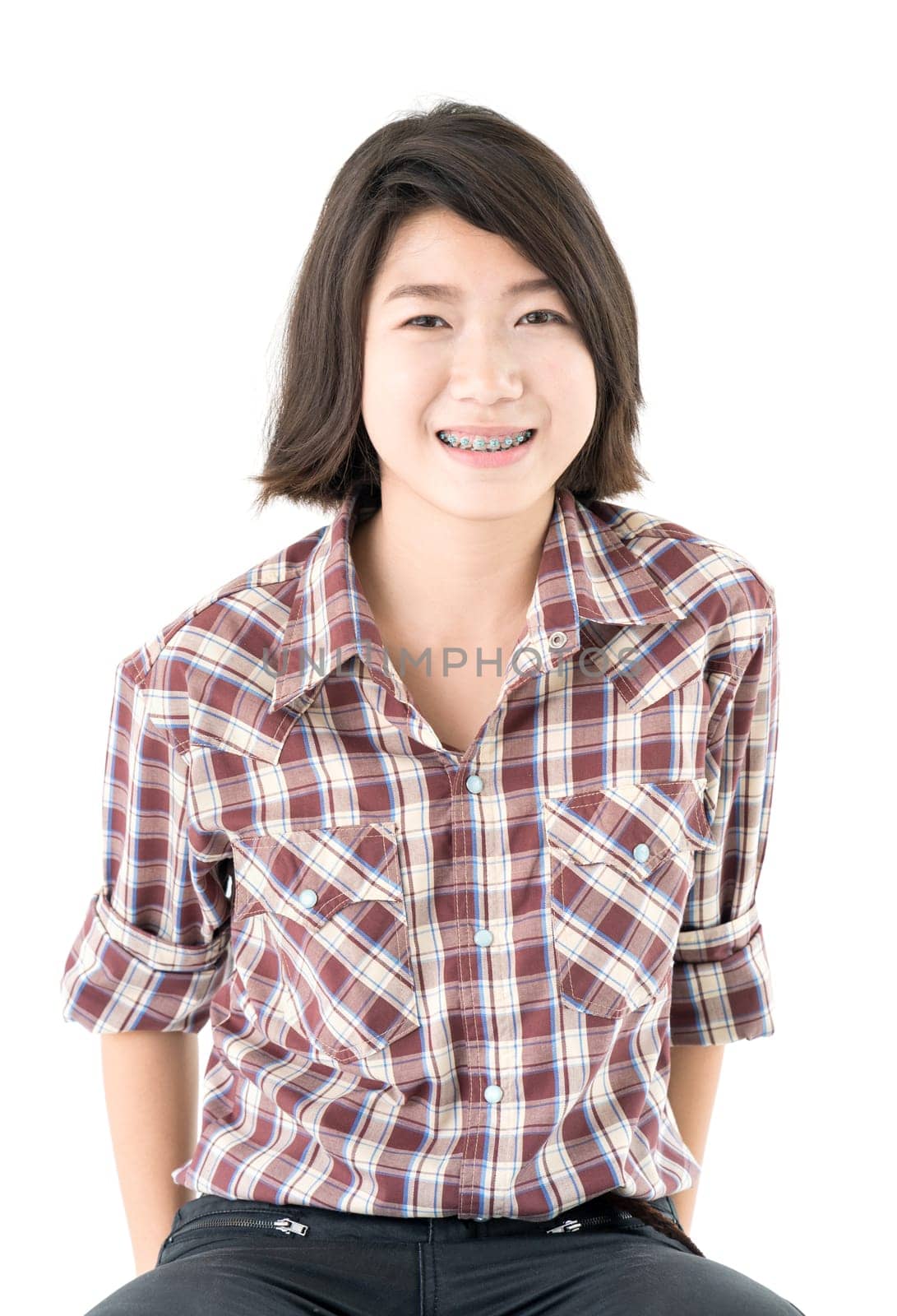 Young pretty woman in plaid shirt posing in studio with isolated on white background