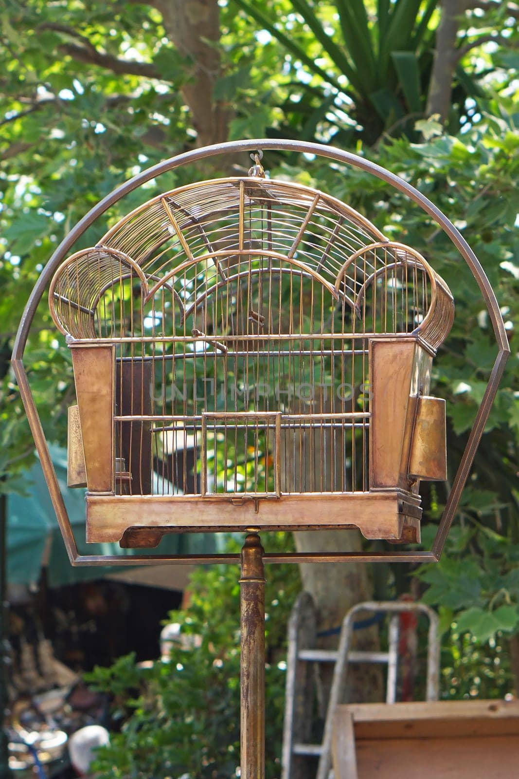 Antique style metal birdcage at pole