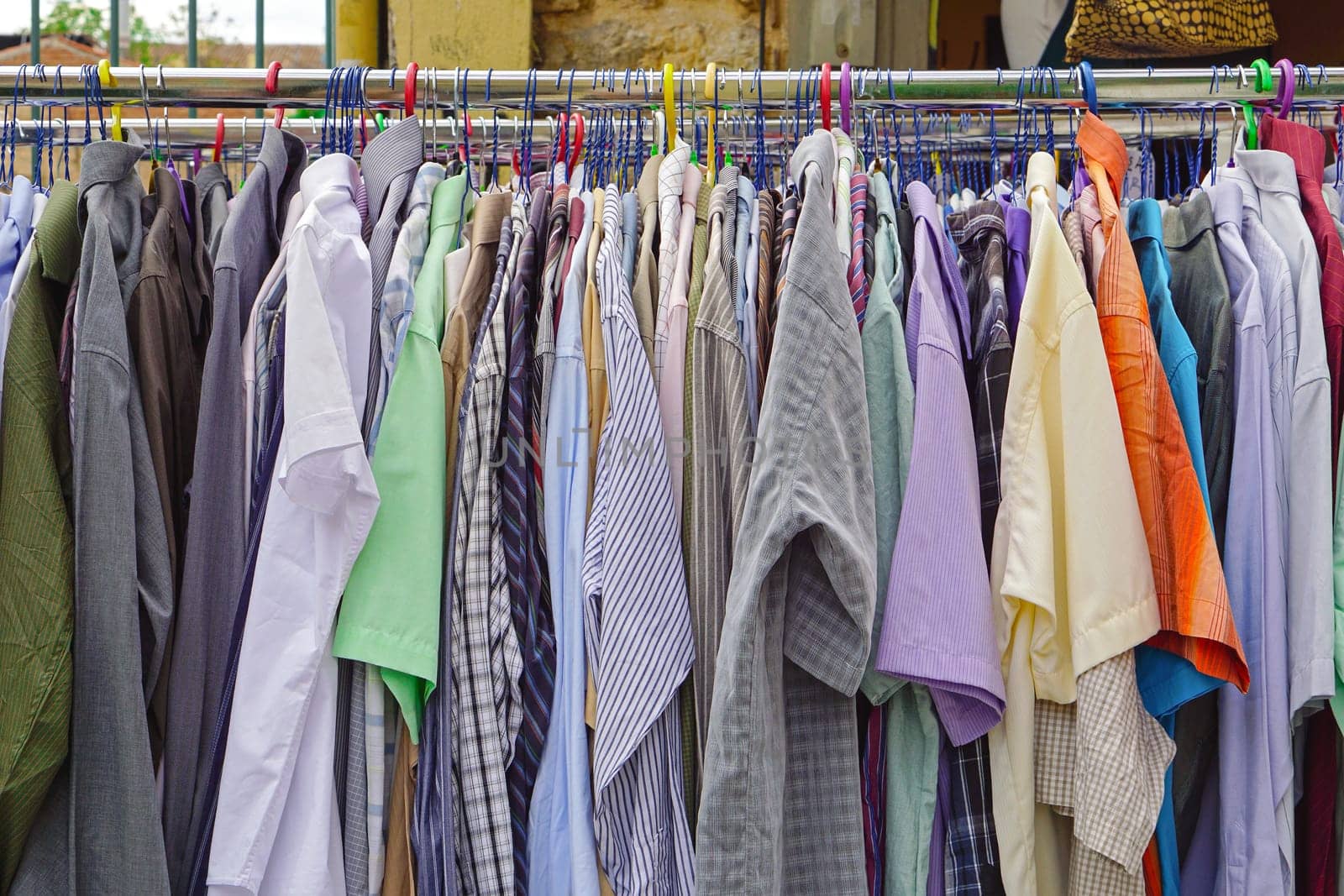 Used shirts hanging at clothes rails