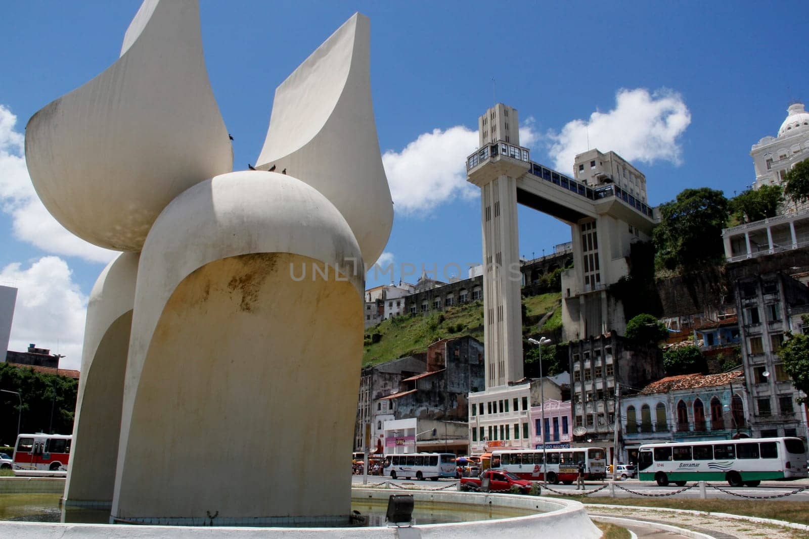 salvador, bahia / brazil - march 21, 2013: sculpture by Mario Cravo in the Comercio neighborhood and in the background the Lacerda Elevator in the city of Salvador.