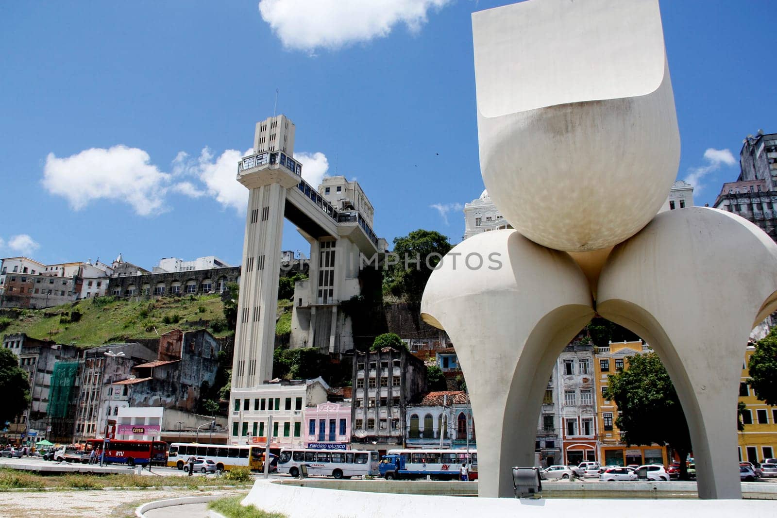 salvador, bahia / brazil - march 21, 2013: sculpture by Mario Cravo in the Comercio neighborhood and in the background the Lacerda Elevator in the city of Salvador.