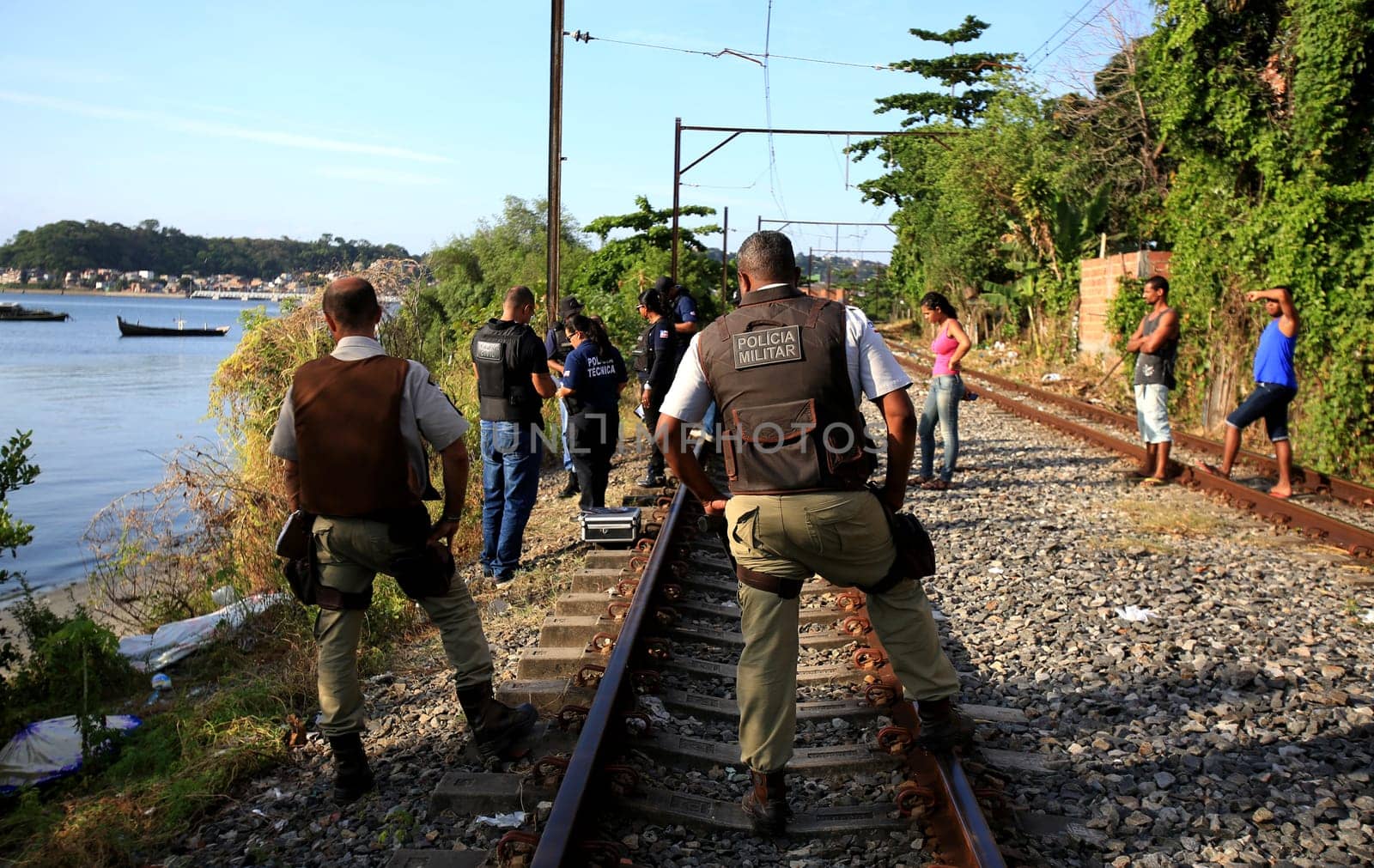 salvador, bahia / brazil - november 23, 2015: civil police investigators are investigating a murdered person near the suburban train line in the city of Salvador.
