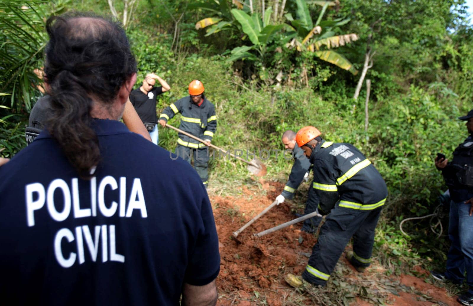 salvador, bahia / brazil - august 24, 2015: civil police investigators are investigating a person murdered in the bush area in the city of Salvador.