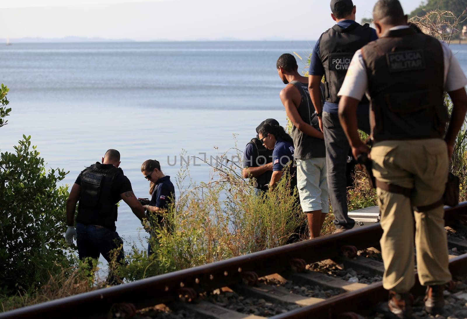 salvador, bahia / brazil - november 23, 2015: civil police investigators are investigating a murdered person near the suburban train line in the city of Salvador.