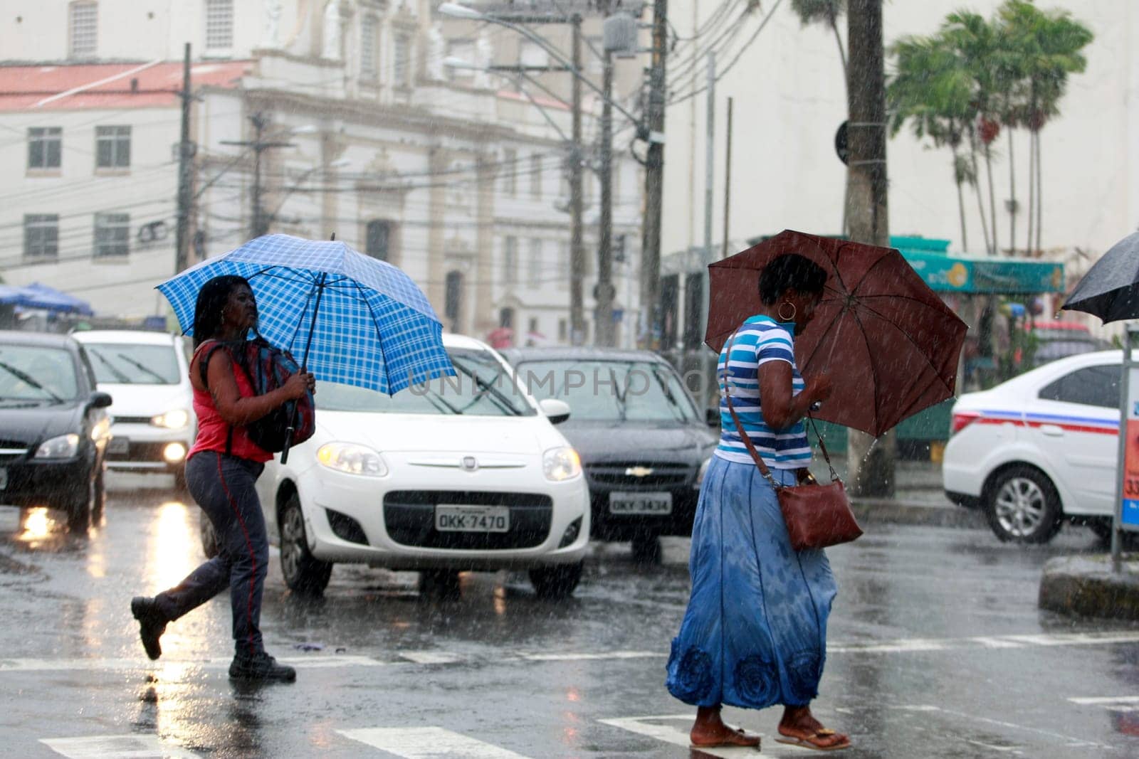 salvador, bahia / brazil - august 26, 2016: People are seen using umbrella during rain in the city of Salvador.