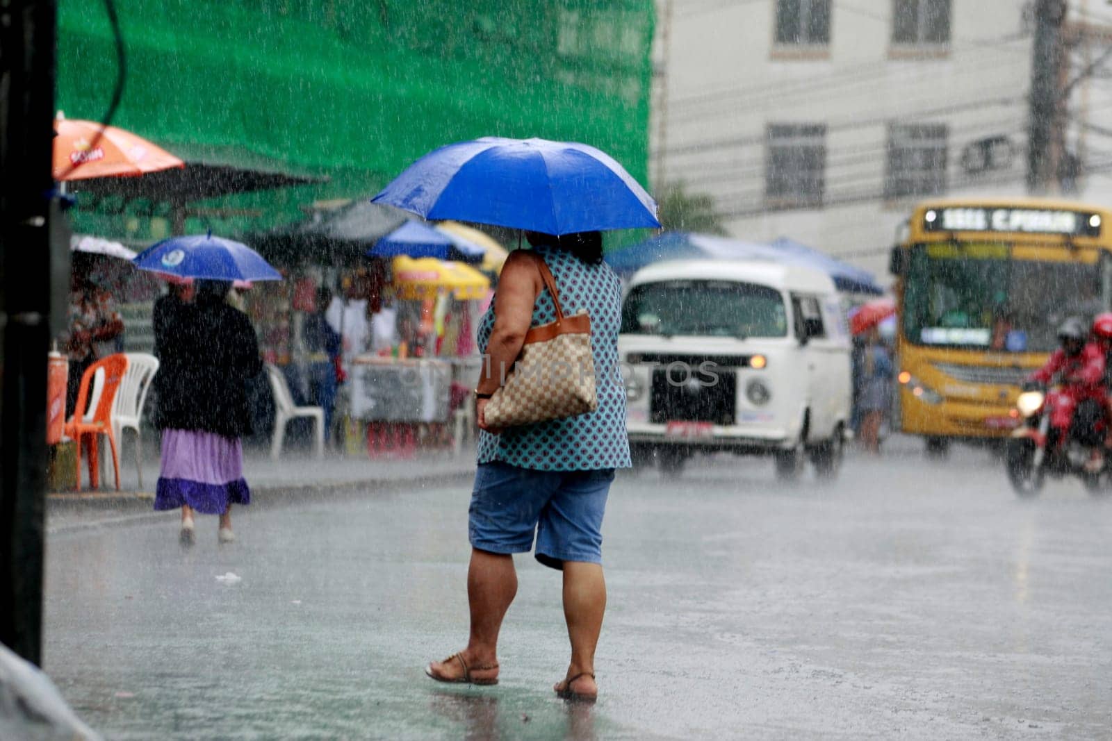 salvador, bahia / brazil - august 26, 2016: People are seen using umbrella during rain in the city of Salvador.